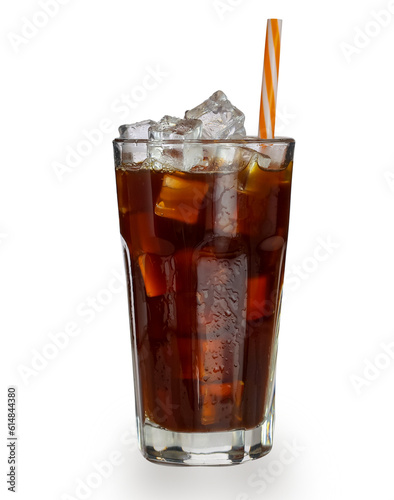 Cold brown drink with transparent tall glass with water droplets. Closeup cold americano coffee with ice cubes and straw side view isolated on white background. 
