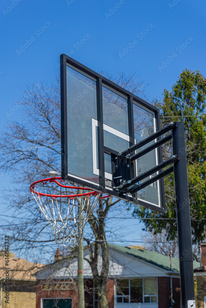 Basketball hoop and backboard on the street of a residential neighbourhood