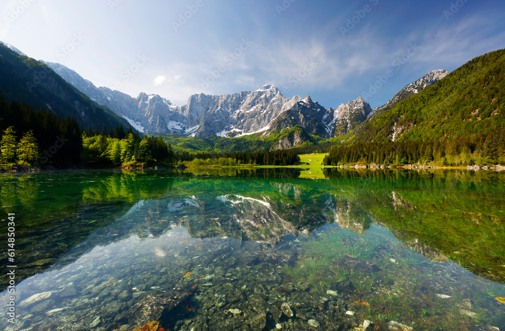 Picturesque mountain scenery and hiking place. Beautiful superior Fusine lake and Mangart mountain in background, Julian Alps, Tarvisio, Udine region, Friuli Venezia Giulia, Italy, Europe	