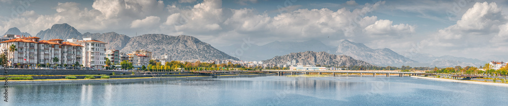 Fototapeta premium Panoramic cityscape view of Antalya resort town, Liman and Hurma district and Taurus mountains in the background