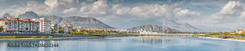 Panoramic cityscape view of Antalya resort town, Liman and Hurma district and Taurus mountains in the background © EdNurg