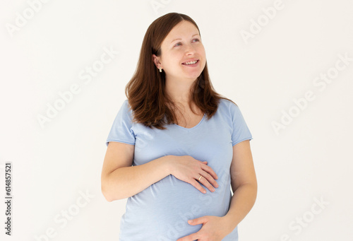 woman enjoying pregnancy, smile, relaxing, hugging belly, isolated on white background © Яна Солодкая