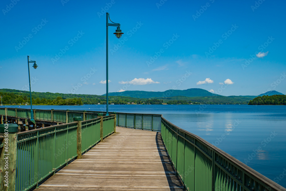 walkway along the shore of Lake Memphremagog in Newport , Vermont looking across at Quebec Canada

