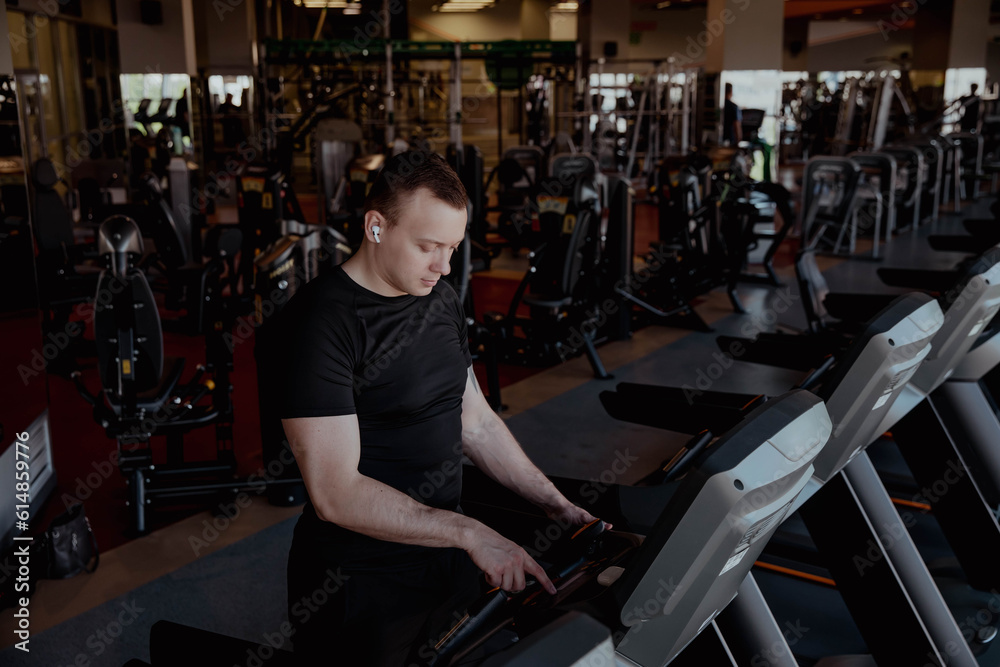 Athlete running on the track in the gym Athlete running on the track in the gym