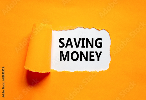 Saving money symbol. Concept words Saving money on beautiful white paper on a beautiful orange background. Business, support and saving money concept. Copy space.