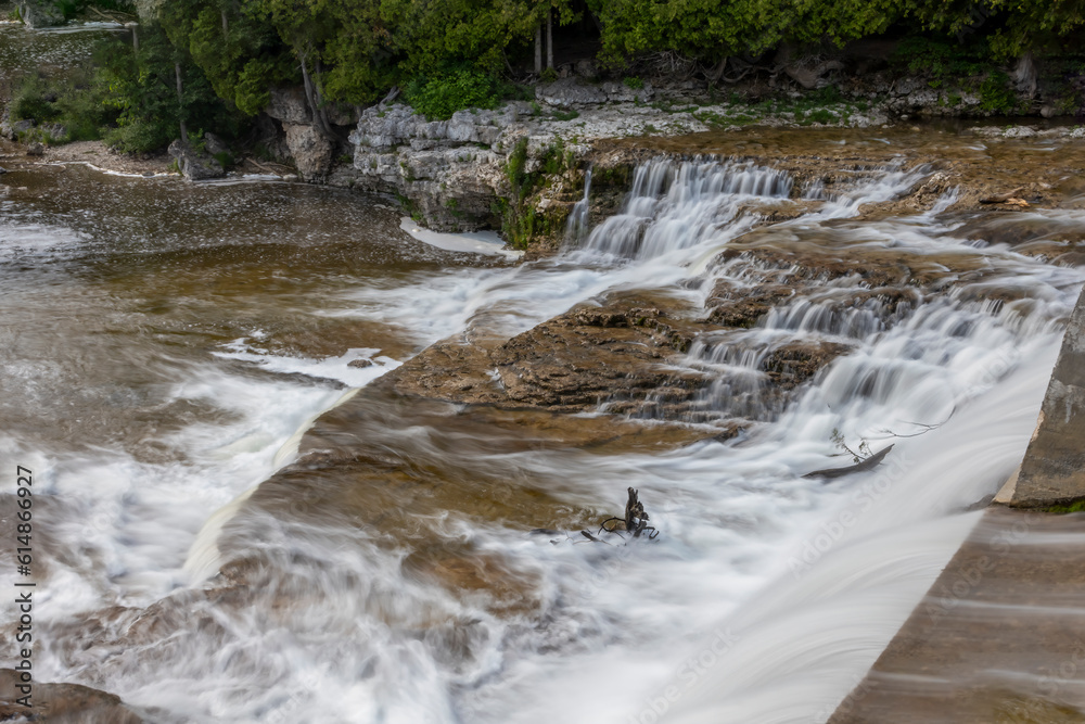 Naklejka premium McGowan Falls in the small town of Durham, Ontario pours over the rocks in the Saugeen River.