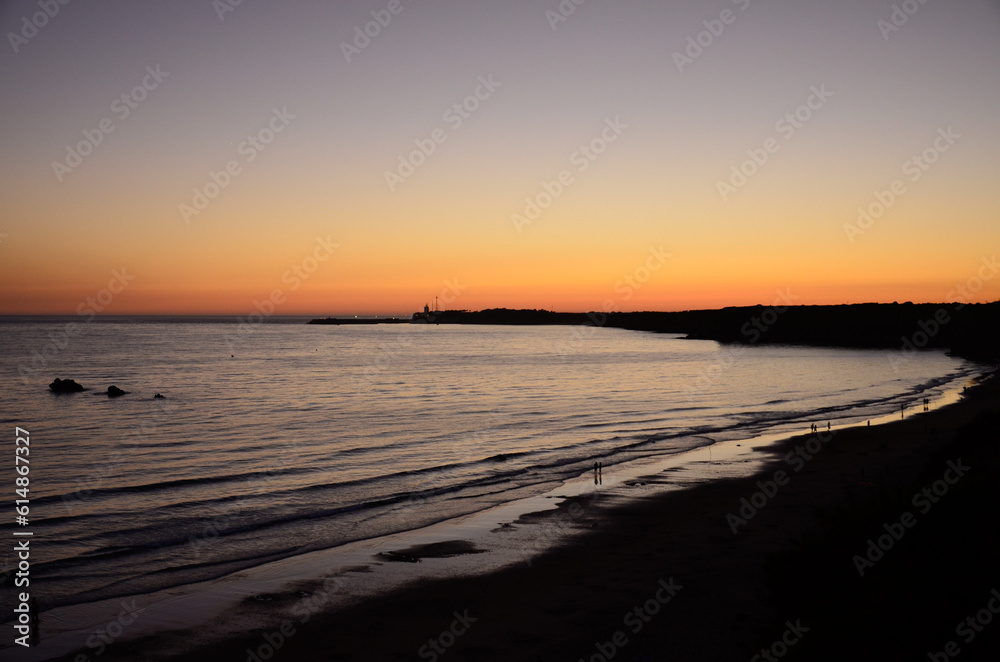 Colorful sky at sunset on the coast of Conil in Spain, overlooking the beach and the Atlantic Ocean