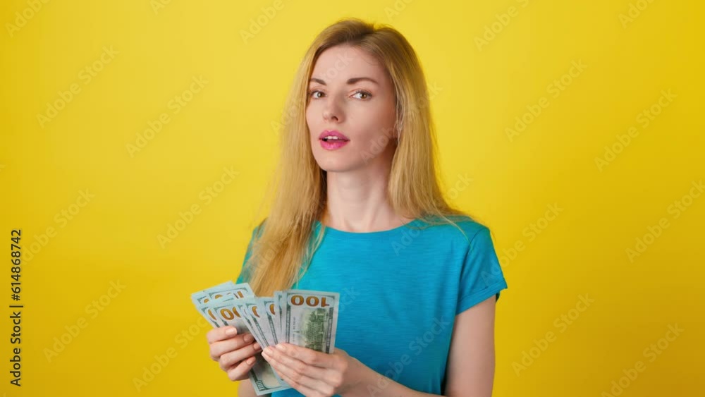 Dollars bills, money cash and winning prize woman celebration financial success. Excited rich lady with lottery win for income, profit or business earnings wealth, startup on yellow background Dollars bills, money cash and winning prize woman celebration financial success. Excited rich lady with lottery win for income, profit or business earnings wealth, startup on yellow background
