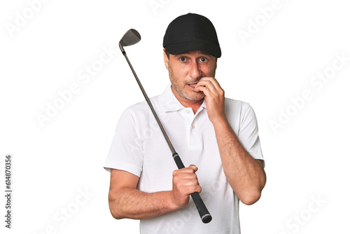 Middle aged golfer man person pointing by hand to a shirt copy space, proud and confident