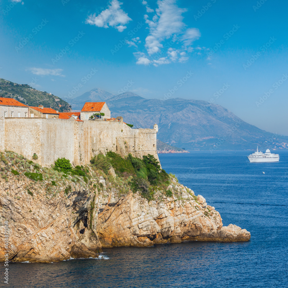 Walls of famous Dubrovnik Old Town (Croatia) and white ship.