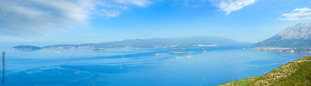 Morning summer panorama of Korcula Island (Croatia) and small islands in front. The view from Peljesac  peninsula. 