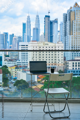 Ideal workspace on a high-rise balcony with a landscape view of the city center