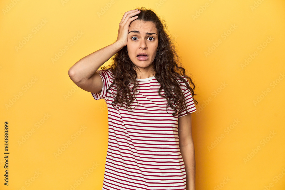 Young Caucasian woman, yellow studio background, being shocked, she has remembered important meeting. Young Caucasian woman, yellow studio background, being shocked, she has remembered important meeting.
