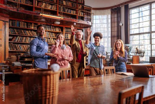 Teacher and students fun in library.