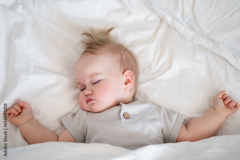 Cute caucasian child toddler sleeps on white sheets Cute caucasian child toddler sleeps on white sheets
