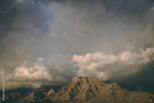 A moody sky sitting above a sinister looking mountain range.