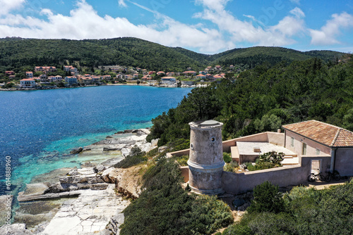 Drone photo with the Venetian lighthouse tower in the small port city of Fiskardo, on the greek island Kefalonia photo