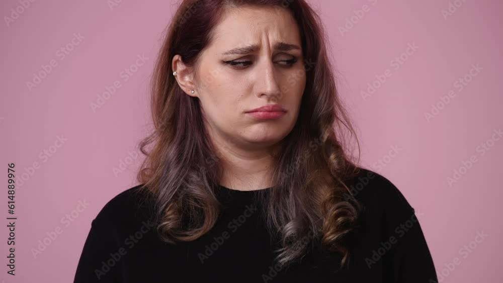 4k video of one woman who sadly posing over pink background. 4k video of one woman who sadly posing over pink background.
