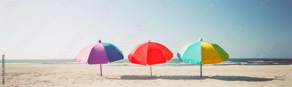 A few colorful parasols, umbrellas on a sunny beach