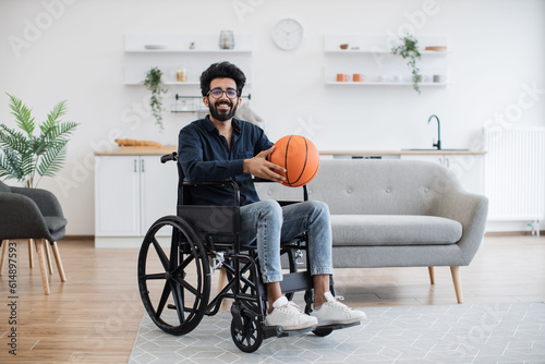Canvastavla Full length portrait of indian adult with mobility issues holding ball in hands before doing daily exercises at home