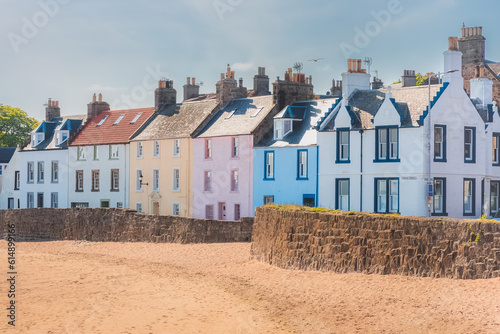 A colourful row of seaside houses on the sandy beach of the quaint coastal fishing village of Anstruther, East Neuk, Fife, Scotland, UK on a sunny summer day.