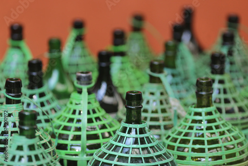 Sequência de garrafões de cachaça em um alambique artesanal em Paraty, cidade intitulada Patrimônio Mundial pela UNESCO. photo