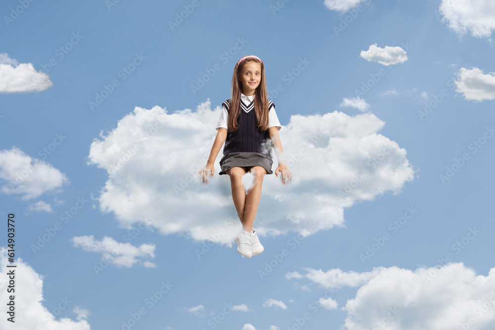 Beautiful schoolgirl with long hair sitting on a cloud Beautiful schoolgirl with long hair sitting on a cloud