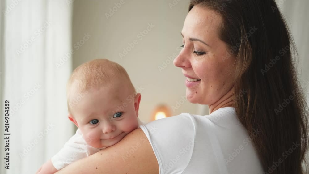 Happy family at home. Mother holding little toddler child daughter. Mom and baby girl relax playing having fun together at home. Mother hugs baby with love care. Mom of breast feeding baby Happy family at home. Mother holding little toddler child daughter. Mom and baby girl relax playing having fun together at home. Mother hugs baby with love care. Mom of breast feeding baby