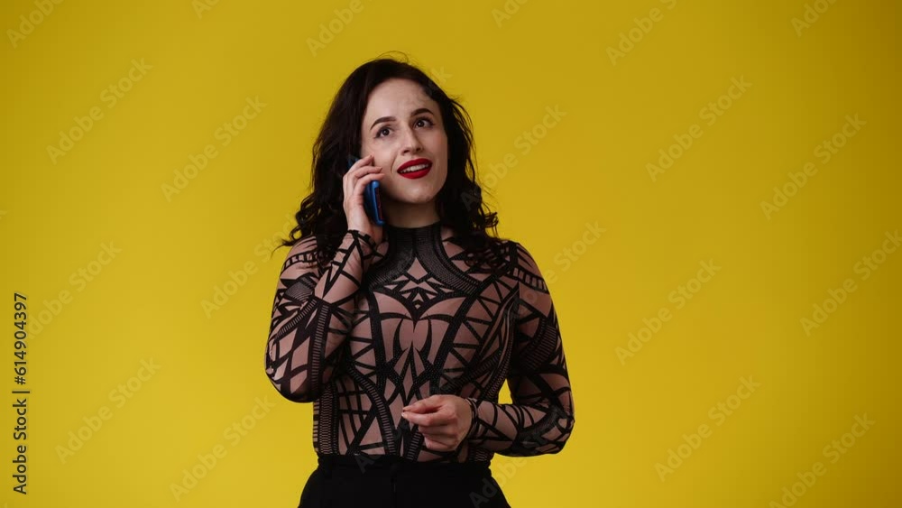 4k video of one woman who after talking on the phone emotionally rejoices over yellow background. 4k video of one woman who after talking on the phone emotionally rejoices over yellow background.