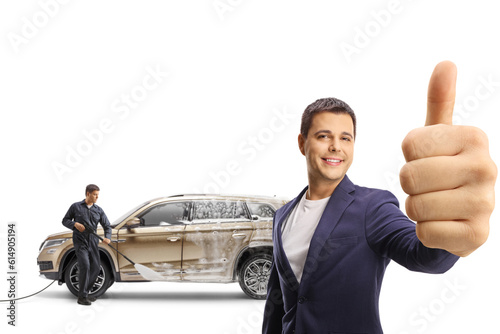 Satisfied customer gesturing thumbs up at a carwash