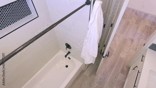 Bathroom High Angle Looking Down Pan Right. slow motion view of a high angle looking down inside a bathroom panning right from shower to vanity and sink area