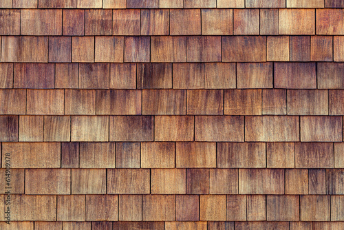 Natural cedar shingle siding.Rough bumpy wood shingle cladding, row of wooden material of small shingle wall facade.Shingle red cedar wooden shake wood siding row roof panel made of larch conifer tree photo