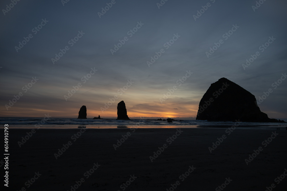 sunset on a beach with rocks sunset on a beach with rocks