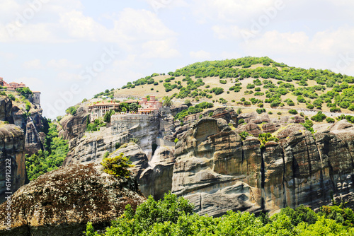 View of a rock with stone buildings on a clear sunny day. Sights of Greece, landscape, World tourism.