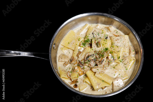 traditional italian creamy wild mushroom pasta with truffle, ceps and porchini, black background photo