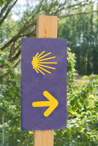sign identifying the Way of St. James with an arrow to guide pilgrims to reach the goal. photo