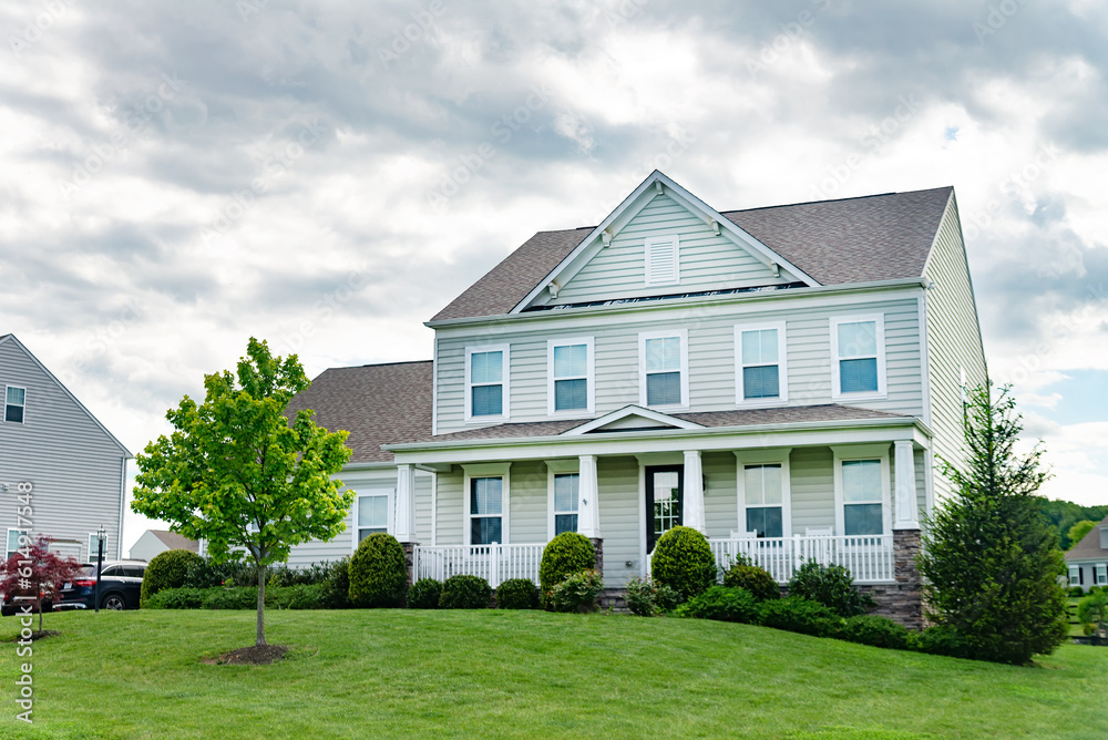 beautiful house with a well-kept and landscaped yard and lawn.