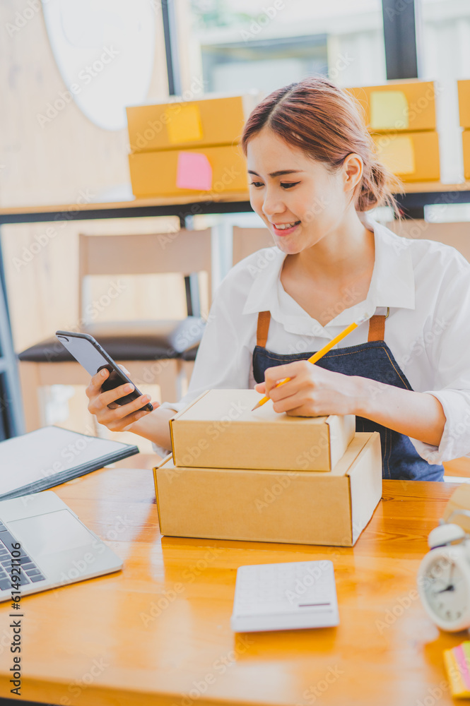Small business owners online are writing their names and addresses to deliver products and products to their customers. and check the orders that the customers - online shopping Small business owners online are writing their names and addresses to deliver products and products to their customers. and check the orders that the customers - online shopping
