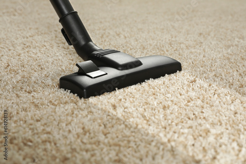 Hoovering carpet with vacuum cleaner, closeup. Clean trace on dirty surface