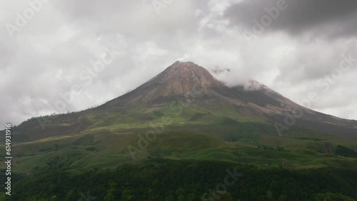 Mount Sinabung active stratovolcano covered with clouds. Sumatra, Indonesia. photo