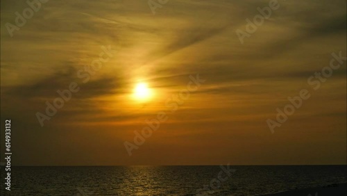 Sunset time lapse with clouds over water