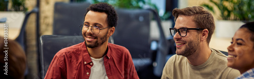 Group of young and happy diverse multi ethnic business people analyzing project results while working together in modern office or coworking space. photo