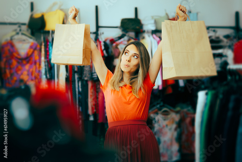 Happy Woman Holding Shopping Bags Feeling Excited. Compulsive shopper feeling endorphin and dopamine rush 
 photo