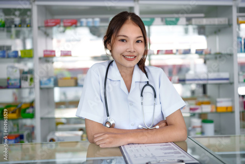 Portrait of asian pharmacist working in pharmacy with medication at pharmacy counter