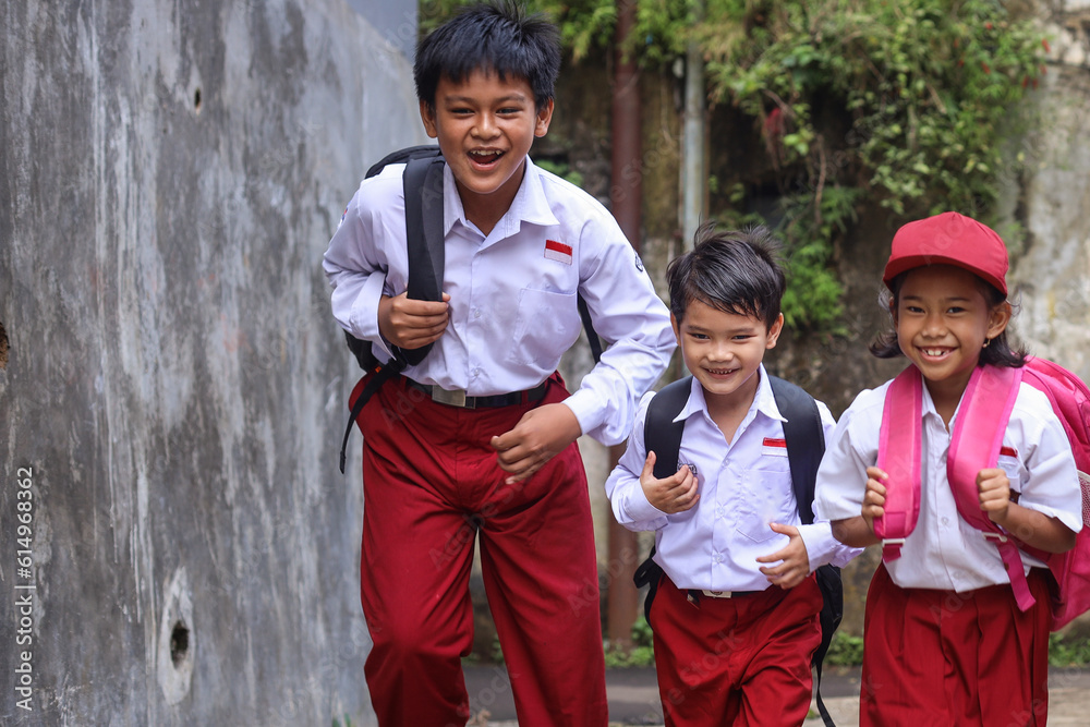Primary School Kids Wearing School Uniforms And Backpacks Running On primary-school-kids-wearing-school-uniforms-and-backpacks-running-on