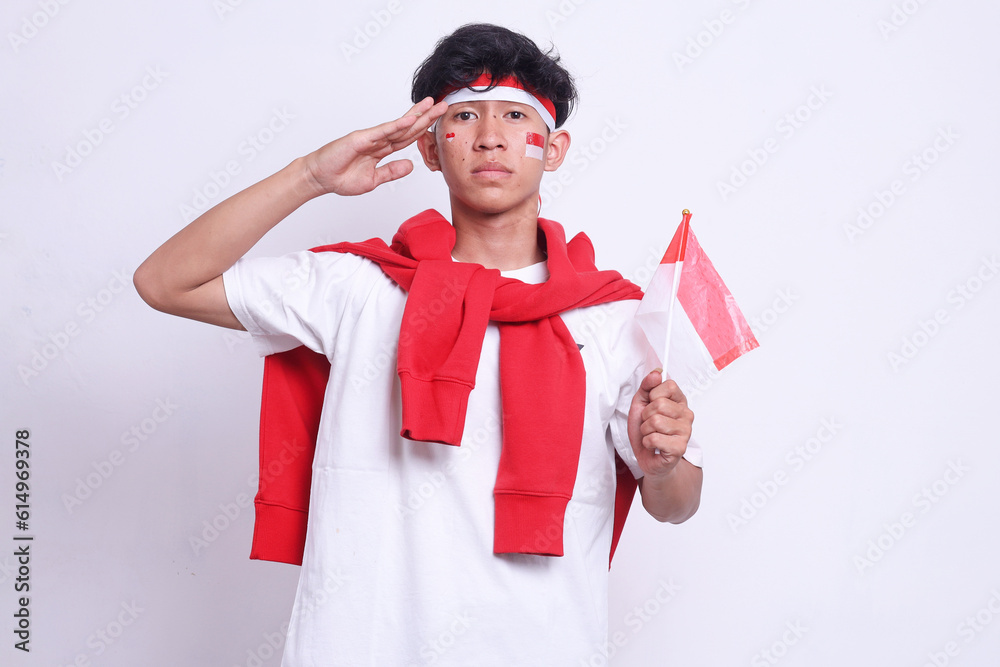 Young man salutes to Indonesian flag
isolated on white background Young man salutes to Indonesian flag
isolated on white background
