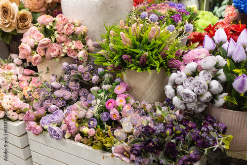Floristry. Compositions of artificial flowers in a gardening store.