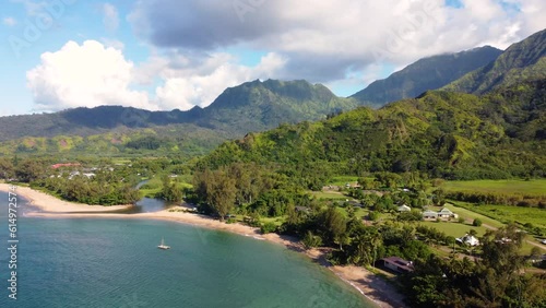 Breathtaking Aerial panoramic shot of Hanalei Valley and green mountains, beach, boat, ocean with the Hanalei River  near Princeville, Kauai, Hawaii photo