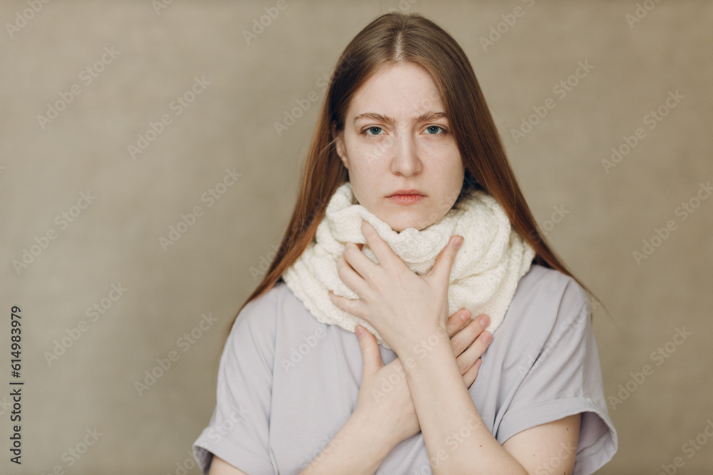 Young woman holding throat wearing scarf flu catarrh ill sick disease treatment cold Young woman holding throat wearing scarf flu catarrh ill sick disease treatment cold