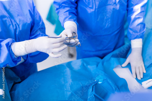 Shot in the Operating Room, Assistant Hands out Instruments to Surgeons During Operation. Surgeons Perform Operation. Professional Medical Doctors Performing Surgery.